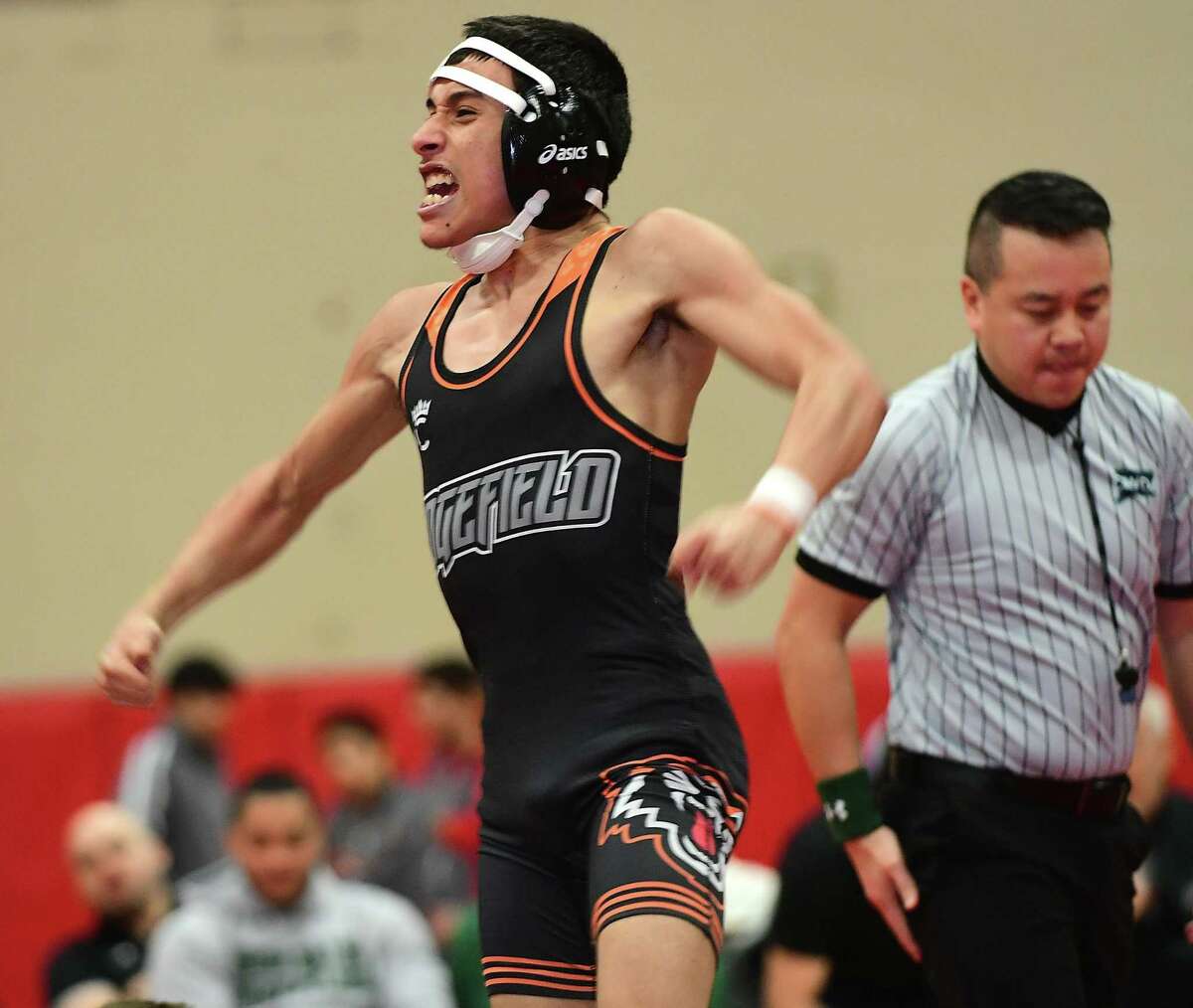 Ridgefield High School wrestler Lexani Pagan celebrates after pinning John Schneider of Brien McMahon in the championship match of the 99-pound exhibition division during the FCIAC wrestling championships in New Canaan.