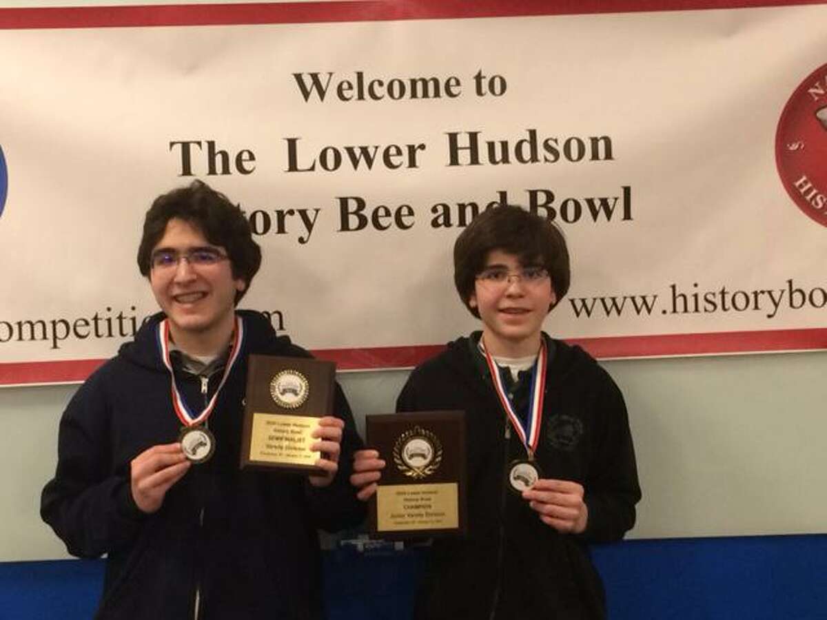 Wilton High School students Alexander, left, and Lukas Koutsoukos show off the medals they won at the Lower Hudson History Bee & Bowl competition on Jan. 11.