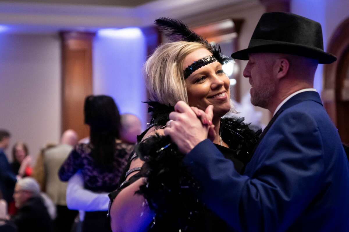 Sarah (left) and Brent Cox (right) dance together during Disability Network of Mid-Michigan's annual fundraising event, Feathers and Fedoras, Saturday, Feb. 15, 2020 at the Great Hall Banquet and Convention Center. (Cody Scanlan/for the Daily News)