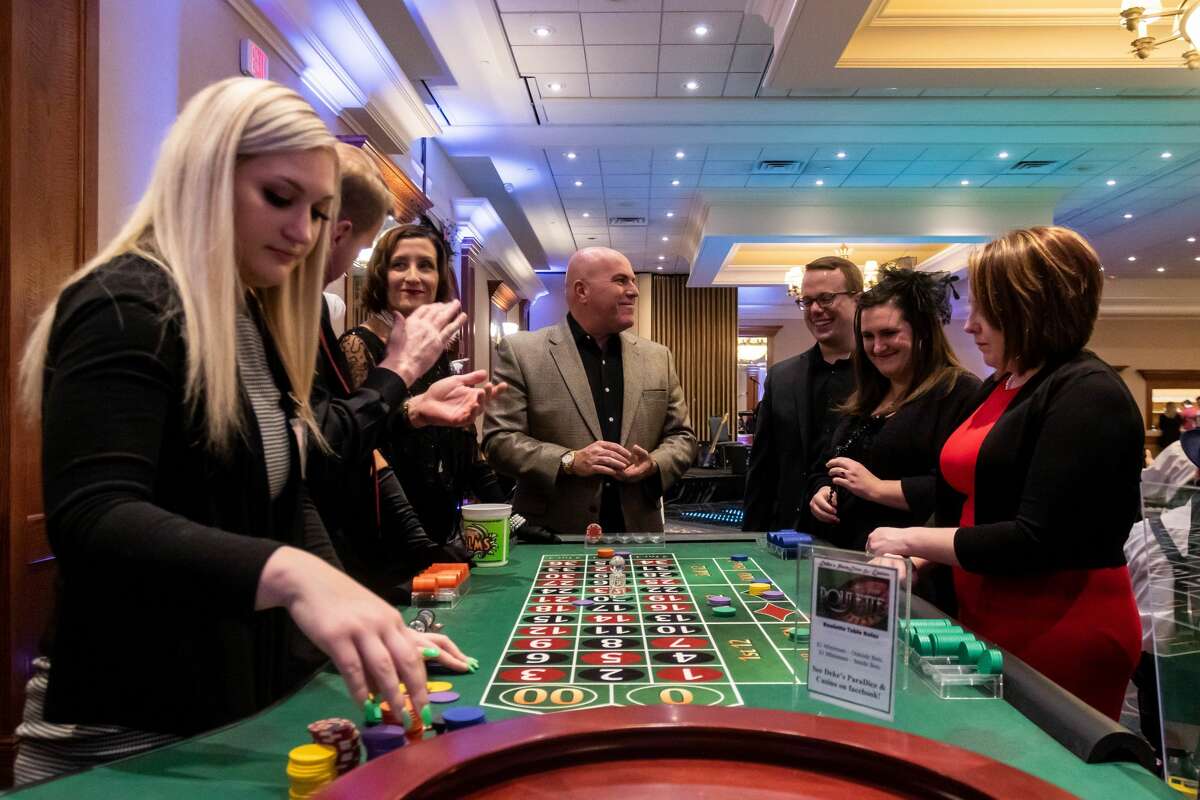 Guests play roulette during Disability Network of Mid-Michigan's annual fundraising event, Feathers and Fedoras, Saturday, Feb. 15, 2020 at the Great Hall Banquet and Convention Center. (Cody Scanlan/for the Daily News)