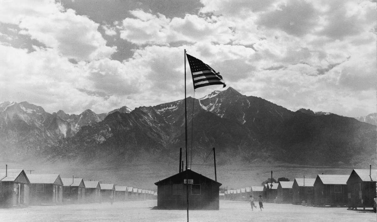 July 1942: A U.S. flag flies at the Manzanar internment camp, which is surrounded by mountains in Manzanar, California.