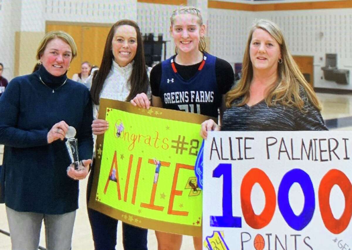 Allie Palmieri is flanked by GFA Director of Athletics Tauni Butterfield, girls’ varsity basketball coach Jen Harris and her mom Wendy Palmieri after scoring her 1,000th career point.