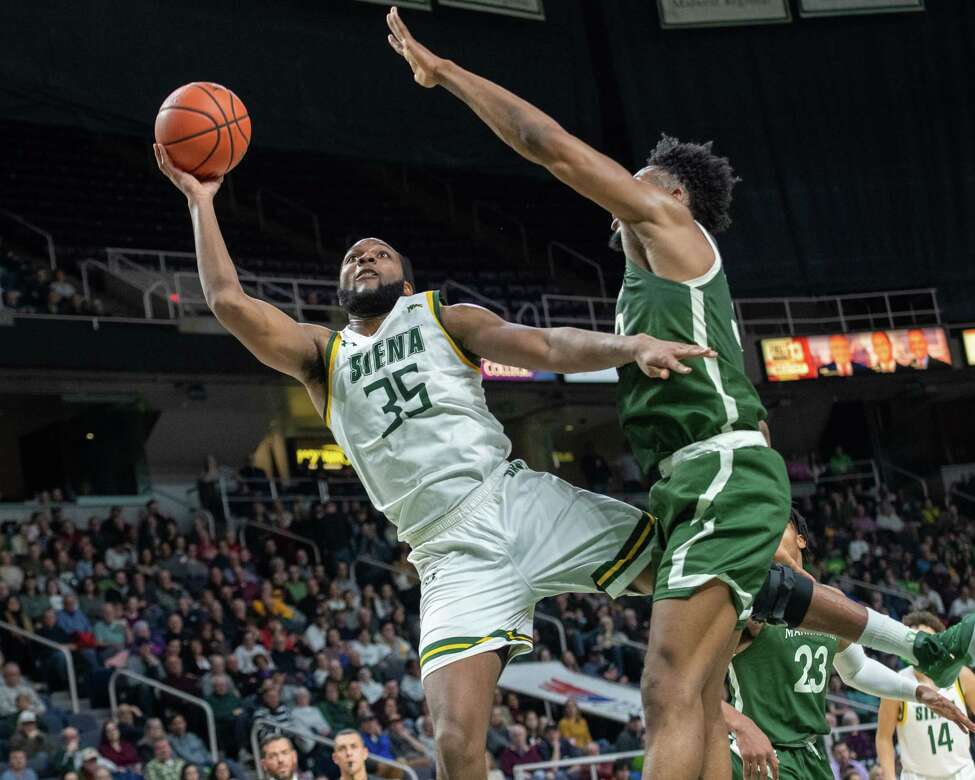 Siena College senior Sammy Friday IV takes a shot in front of Manhattan senior Pauly Paulicap during a Metro Atlantic Athletic Conference game at the Times Union Center in Albany, NY on Sunday, Feb. 16, 2020 (Jim Franco/Special to the Times Union.)