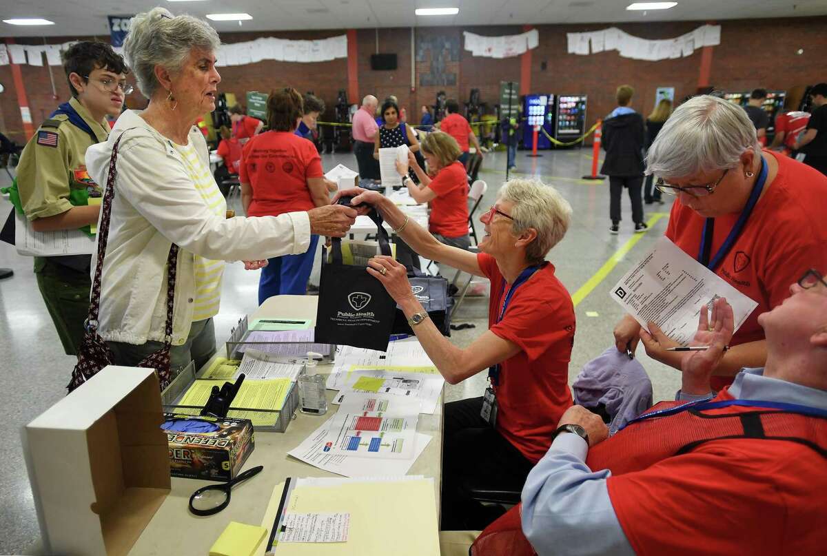 Playing the role of a patient, Stamford CERT volunteer Muffy Munger receives medication from Trumbull Health Department nurse Grace Vetter, RN, during a drill for the mass dispersing of medication at Trumbull High School in Trumbull, Conn. on Tuesday, June 25, 2019. The drill, featuring Medical Reserve Corps volunteers from Trumbull, Stratford, and Monroe, simulated the dispensing of antibiotics in response to an anthrax incident on a Metro North train.
