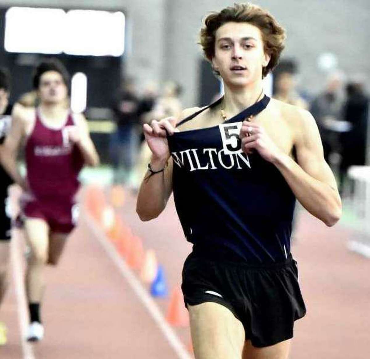 Davis Cote celebrates at the end of his victory in the 1,000-meter race at the Class L boys indoor track and field state championship.