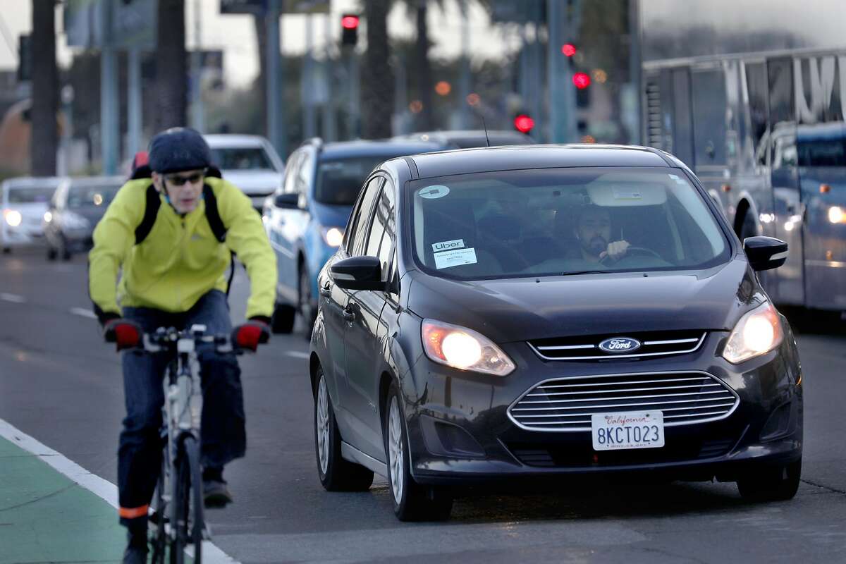 An Uber car waits at a traffic light on the Embarcadero at Mission St. on Wednesday, Jan. 29, 2020, in San Francisco, Calif.