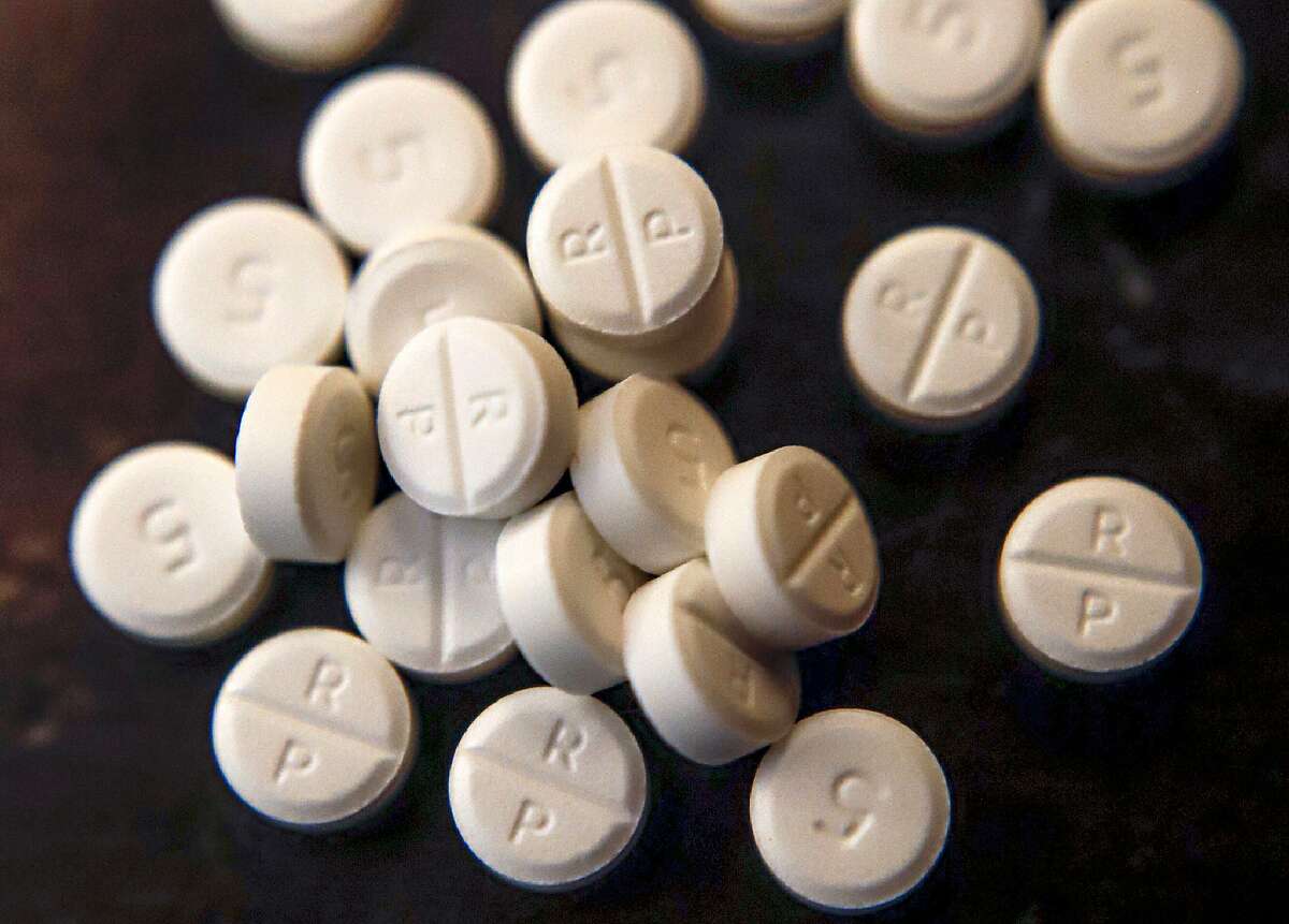 FILE - This June 17, 2019, file photo shows 5-mg pills of Oxycodone. A federal judicial panel is sending two federal opioid lawsuits back to federal courts in Oklahoma and California in an effort to streamline the cases. The Judicial Panel on Multidistrict Litigation accepted a recommendation from U.S. District Judge Dan Polster in Ohio. Polster is overseeing nearly 2,700 lawsuits brought by local governments, Native American tribes, hospitals and unions against various manufacturers, distributors and pharmacies over the opioid crisis that is blamed for more than 400,000 deaths since 2000. (AP Photo/Keith Srakocic, File)