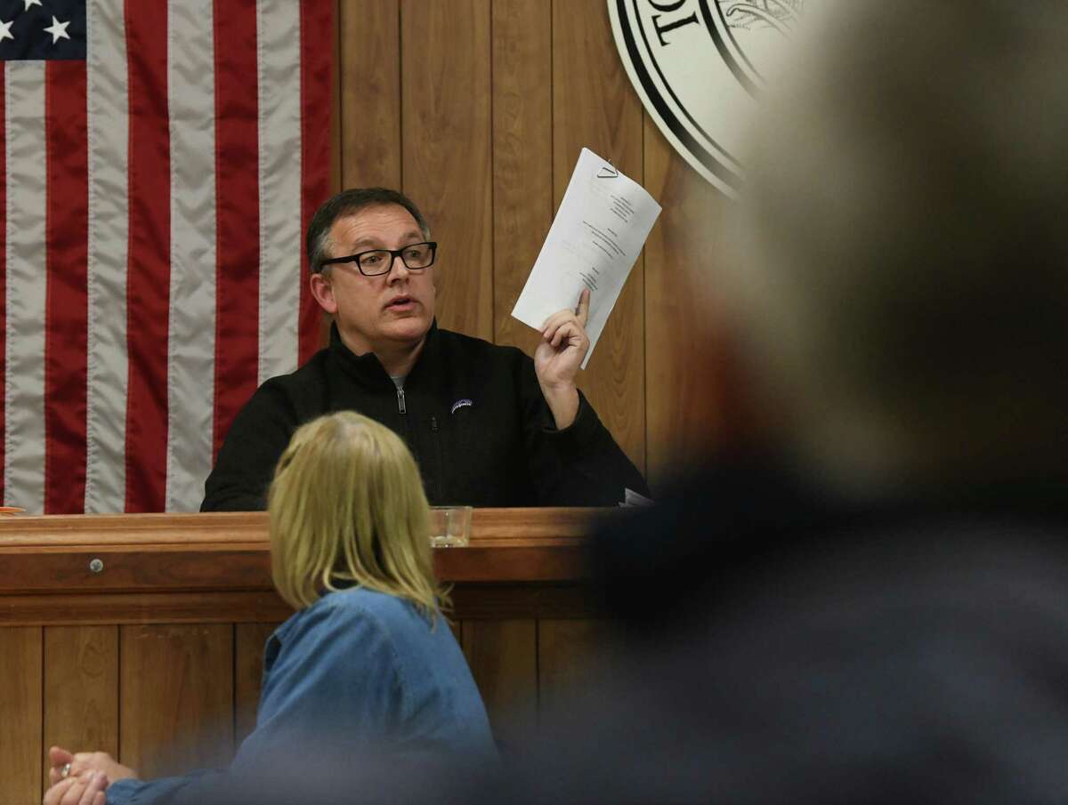 Heinz Noeding holds up the meeting agenda as people attend a town board meeting on Monday, Feb. 17, 2020 in Petersburgh, N.Y. The town board is considering whether to cap the amount of any settlement over PFOA contamination in a landfill Petersburgh shares with neighboring Berlin. (Lori Van Buren/Times Union)