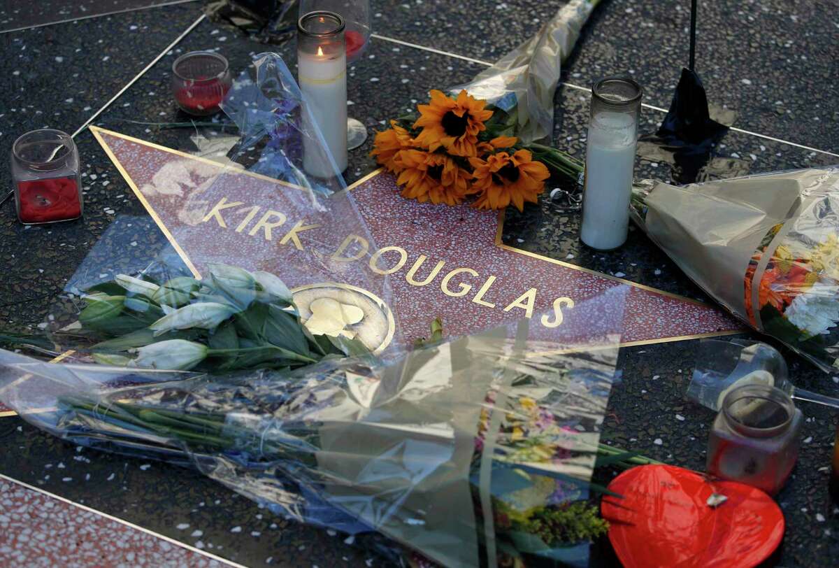 Flowers adorn actor Kirk Douglas’ star on the Hollywood Walk of Fame, Thursday, Feb. 6, 2020, in Los Angeles. Douglas, the muscular actor with the dimpled chin who starred in “Spartacus,” “Lust for Life” and dozens of other films and helped fatally weaken the Hollywood blacklist, died at 103, on Wednesday. (AP Photo/John Locher)