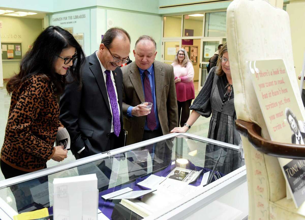 University at Albany President Havid‡n Rodr’guez, center, and his wife, Rosy Lopez, left, are given a tour of the new Toni Morrison exhibit by Paul Grondahl, director of the New York State Writers Institute, right, on Tuesday, Feb. 18, 2020, at the University at Albany Science Library Atrium in Albany, N.Y. The exhibit features papers, photographs and archival items, as well as Morrison?•s office chair from her time at UAlbany. (Will Waldron/Times Union)