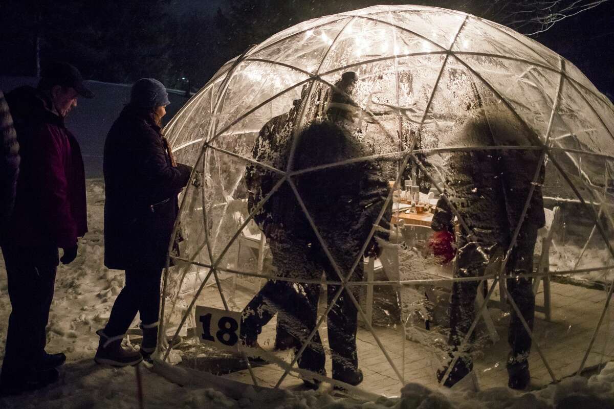 Diners enjoy an eight-course meal inside heated igloo tents during the Eat Great Winter event, hosted by Octagon, Monday, Feb. 17, 2020 at Dow Gardens. (Katy Kildee/kkildee@mdn.net)