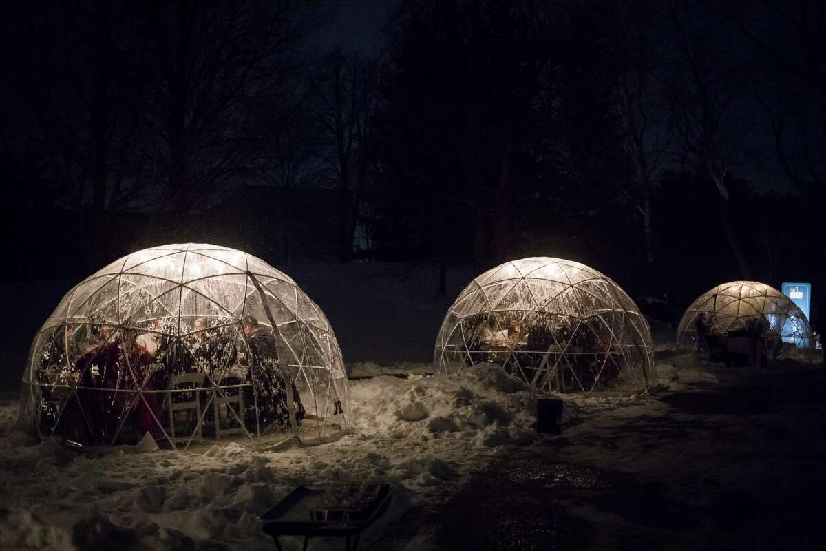 Diners enjoy an eight-course meal inside heated igloo tents during the Eat Great Winter event on Monday, Feb. 17, 2020 at Dow Gardens. This year's Eat Great Winter is being held at Bay City's Wenonah Park from Sunday through Tuesday.