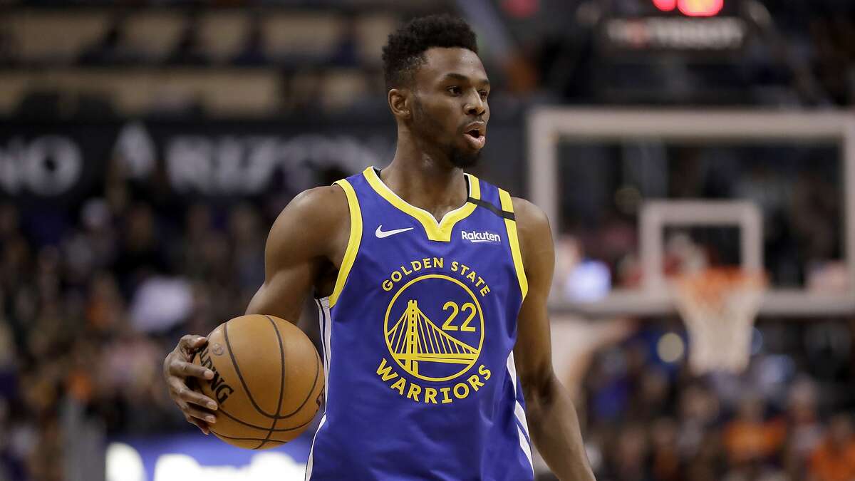 Golden State Warriors guard Andrew Wiggins (22) looks to pass against the Phoenix Suns during the second half of an NBA basketball game, Wednesday, Feb. 12, 2020, in Phoenix. (AP Photo/Matt York)
