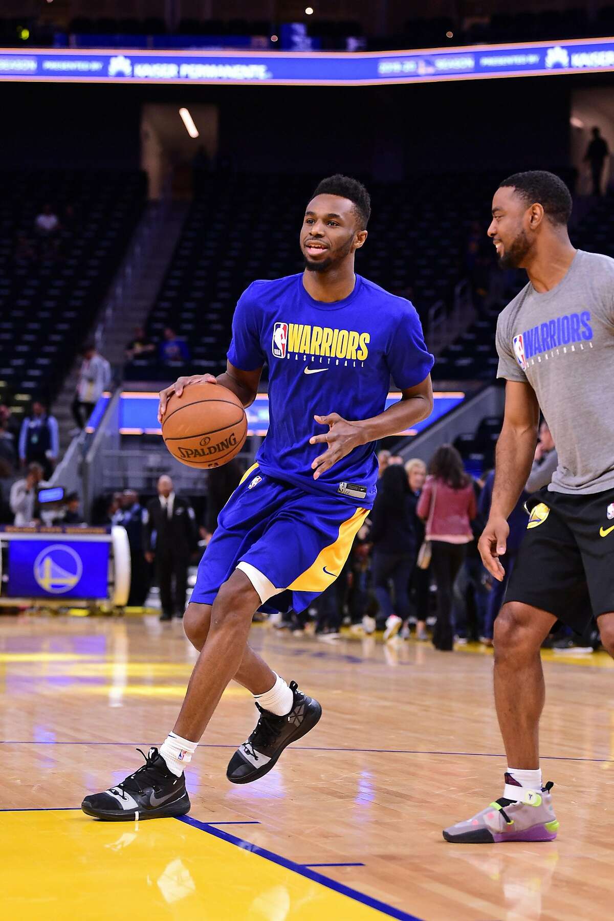 Warriors forward Andrew Wiggins warms up with player-development coach Aaron Miles before Golden State's Feb. 8 loss to the Lakers.