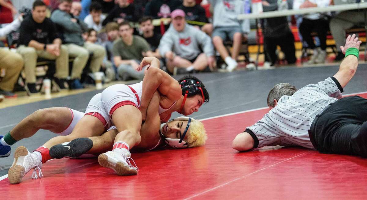 Carlos DeWinter, of Greenwich, top, won the 120-pound weight class title at the FCIAC Championships on Saturday, February 15, 2020, at New Canaan High School in New Canaan, Connecticut.