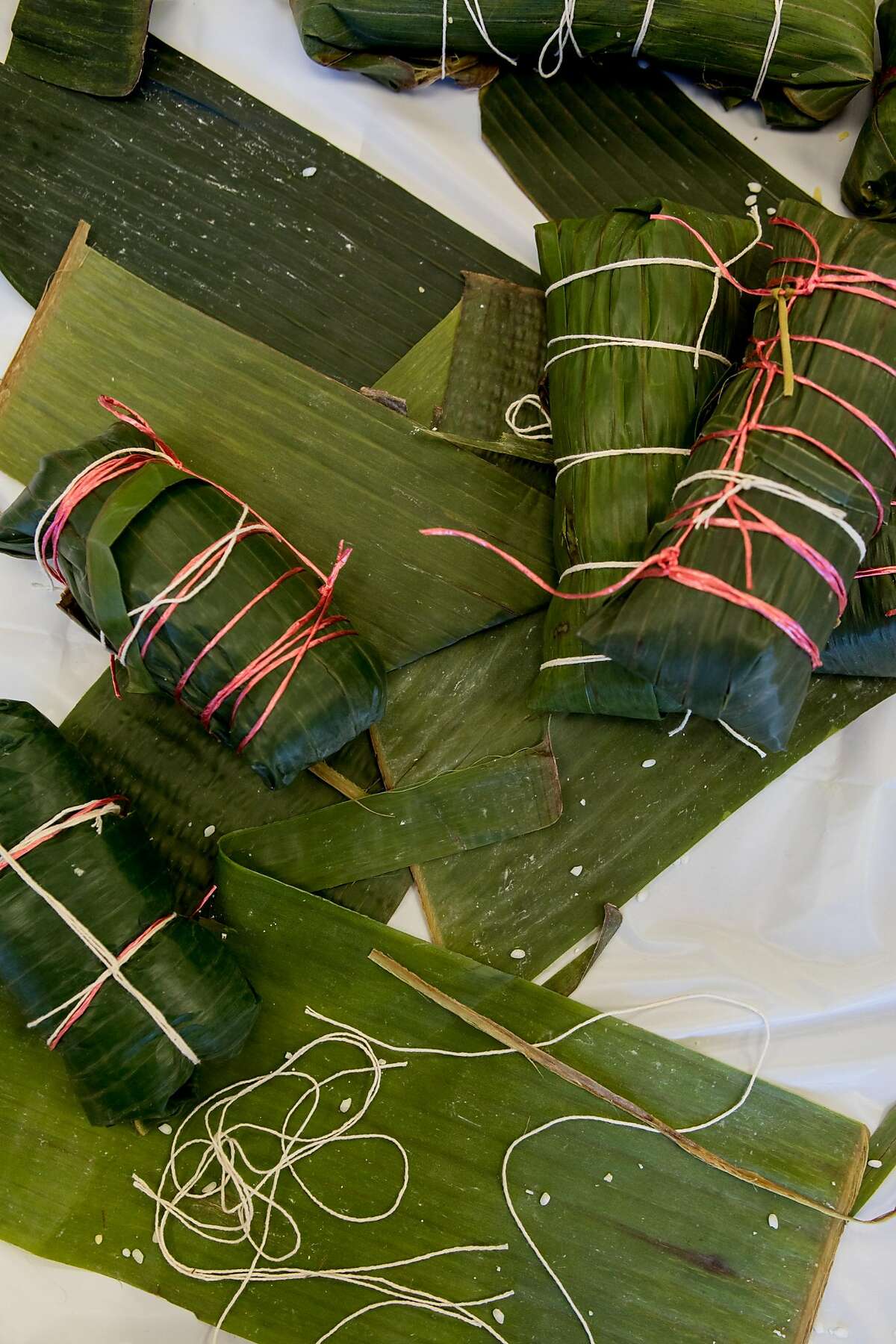 Elders are experts in tying b�nh t�t, a parcel of sticky rice, mung beans, and sweet yams wrapped in banana leaves in San Jose on February 8, 2020.