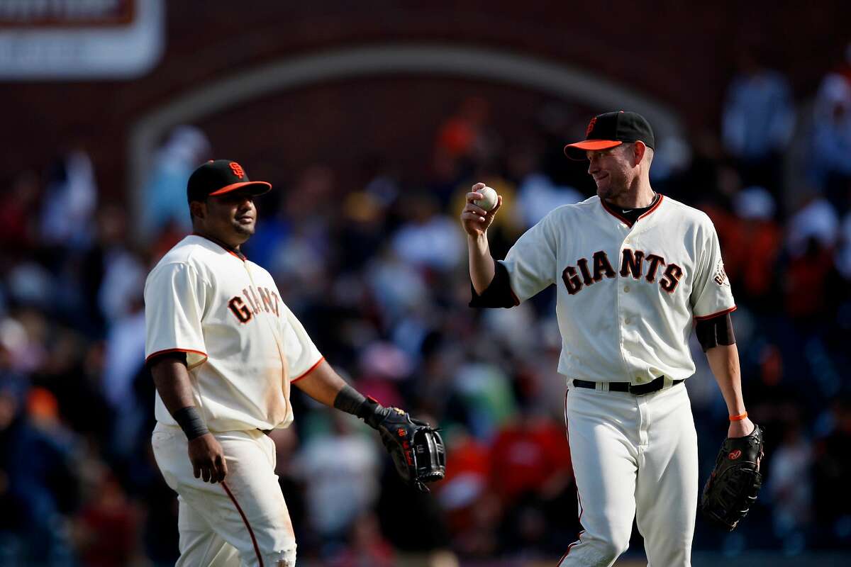 Pablo Sandoval (left) and Aubrey Huff celebrate the Giants' victory over the Milwaukee Brewers in San Francisco on Sunday.