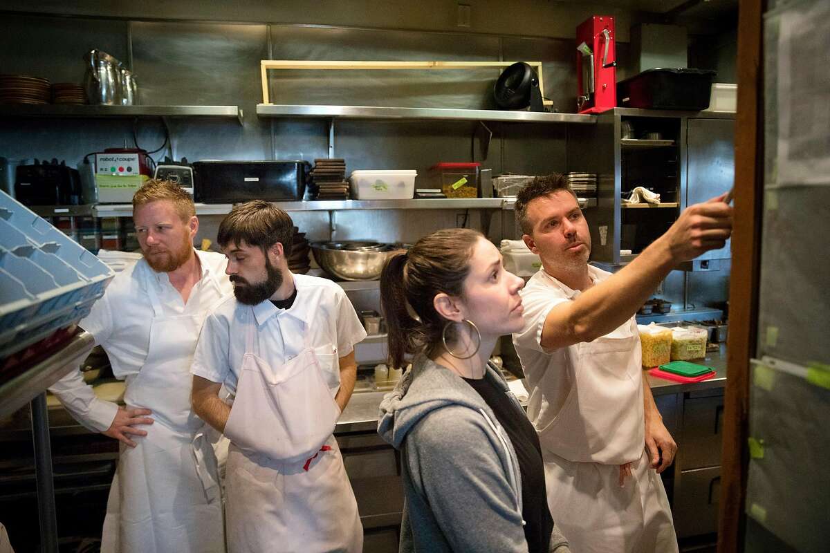 Chef Thomas McNaughton checks in with Benjamin Moeller (Sous Chef at Flour+Water), Amanda Flores (General Manager of Flour+Water), and Ryan Pollnow (Executive Chef of Ne Timeas Restaurant Group) as they oversee the dinner menu at Flour + Water restaurant in San Francisco, Calif., on Wednesday, February 12, 2020. Contemporary Italian restaurant Flour + Water has become one of San Francisco?s most popular restaurants since it opened in 2009. Founders McNaughton and partners went on to found Ne Timeas Restaurant Group, one of roughly two-dozen small, local restaurant groups that have emerged in San Francisco in recent years. These groups are responsible for some of the city’s most popular restaurants, managing to endure the steep challenges of opening and keeping afloat a mid-priced to upscale restaurant in San Francisco.
