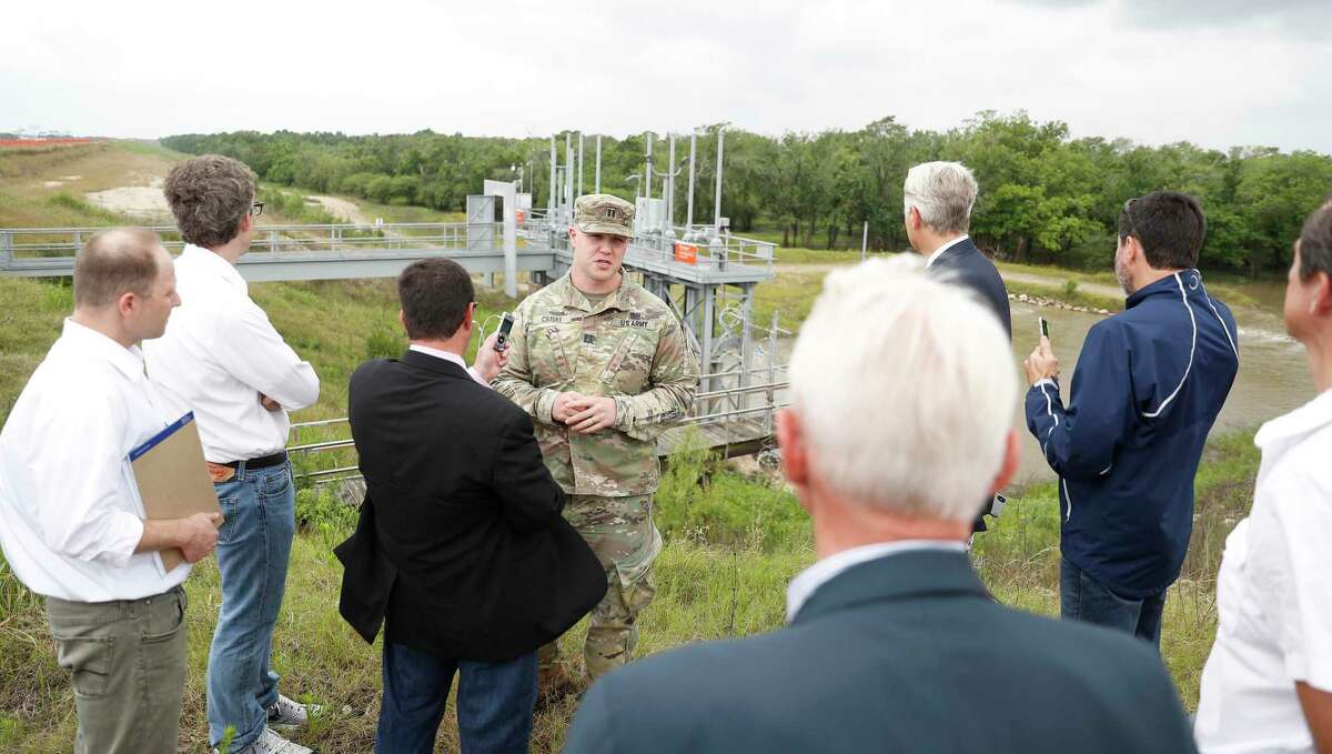 Captain Charles Ciliske with the US Army Corps of Engineers is audio recorded by court reporter David Lee as U.S. Judge Charles Lettow, foreground, listens to his testimony on the top of Barker Reservoir, as the homeowners suing after Harvey went out to view homes in the Addics and Barker Dam areas, in Houston, Wednesday, May 8, 2019.