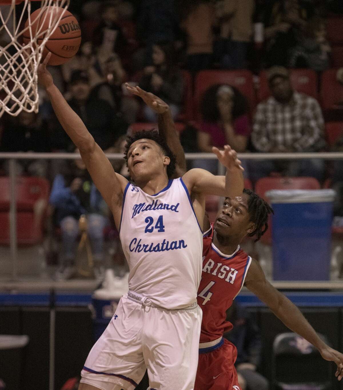 Midland Christian's Joseph Venzant goes in for a layup as Dallas Parish's Vinnie Gaddis tries to defend 02/18/2020 in the TAPPS 6A playoff at the McGraw Event Center. Tim Fischer/Reporter-Telegram