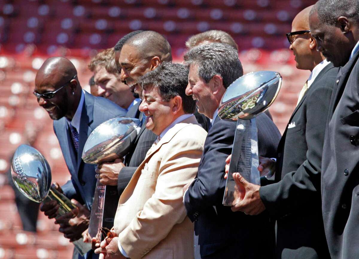 Members of the San Francisco 49ers Super Bowl teams, from left, Jerry Rice, Roger Craig and Ronnie Lott hoist Super Bowl trophies alongside former team owner Eddie DeBartolo, in light jacket, and former team president Carmen Policy during a memorial for former 49ers NFL football coach Bill Walsh on Friday, Aug. 10, 2007, in San Francisco. (AP Photo/San Francisco Chronicle, Chris Stewart) **NO SALES MAGS OUT MANDATORY CREDIT **