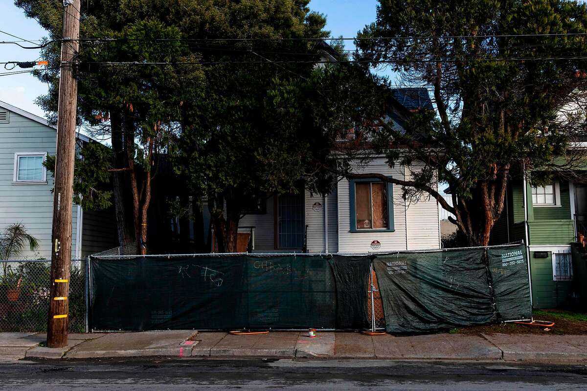 A newly-erected fence blocks the front of a vacant home that Moms 4 Housing activists occupied during a months-long protest, which ended in a court ordered eviction. (Photo by Philip Pacheco / AFP) (Photo by PHILIP PACHECO/AFP via Getty Images)