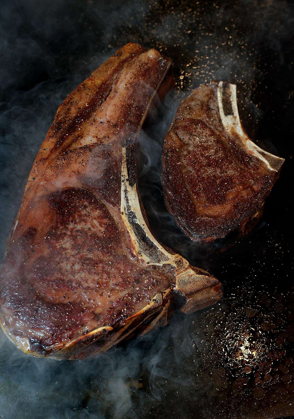 Two tomahawk steaks being grilled at Perry Lang’s, a new contemporary steakhouse in Yountville, Calif., on Thursday, February 13, 2020.
