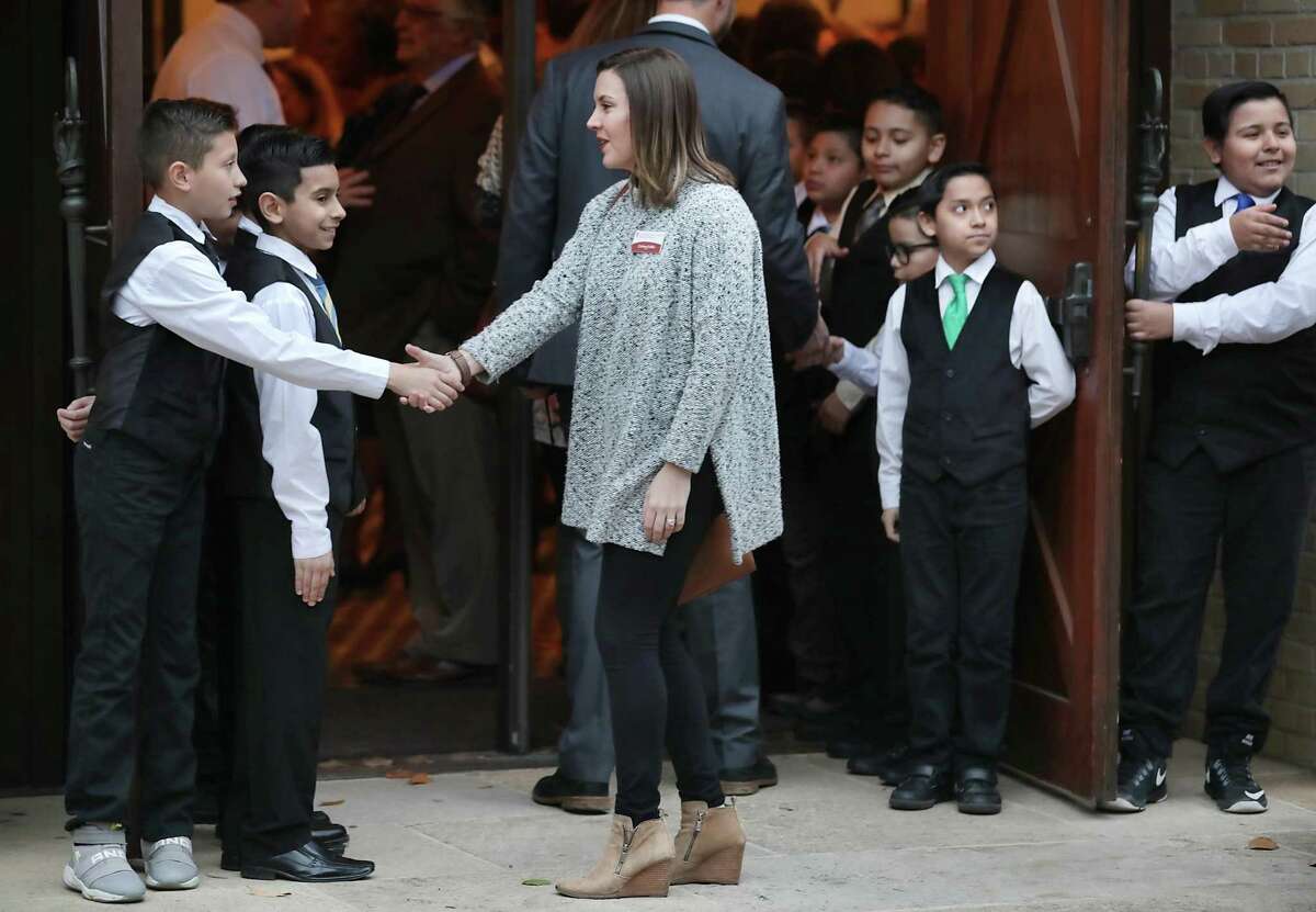 Cadence Corbin of the San Antonio Area Foundation is greeted by members of the Caballeros Distinguidos from Briscoe Elementary School as she enters the Pearl Stable on Wednesday for the annual State of the District speech given by SAISD Superintendent Pedro Martinez.