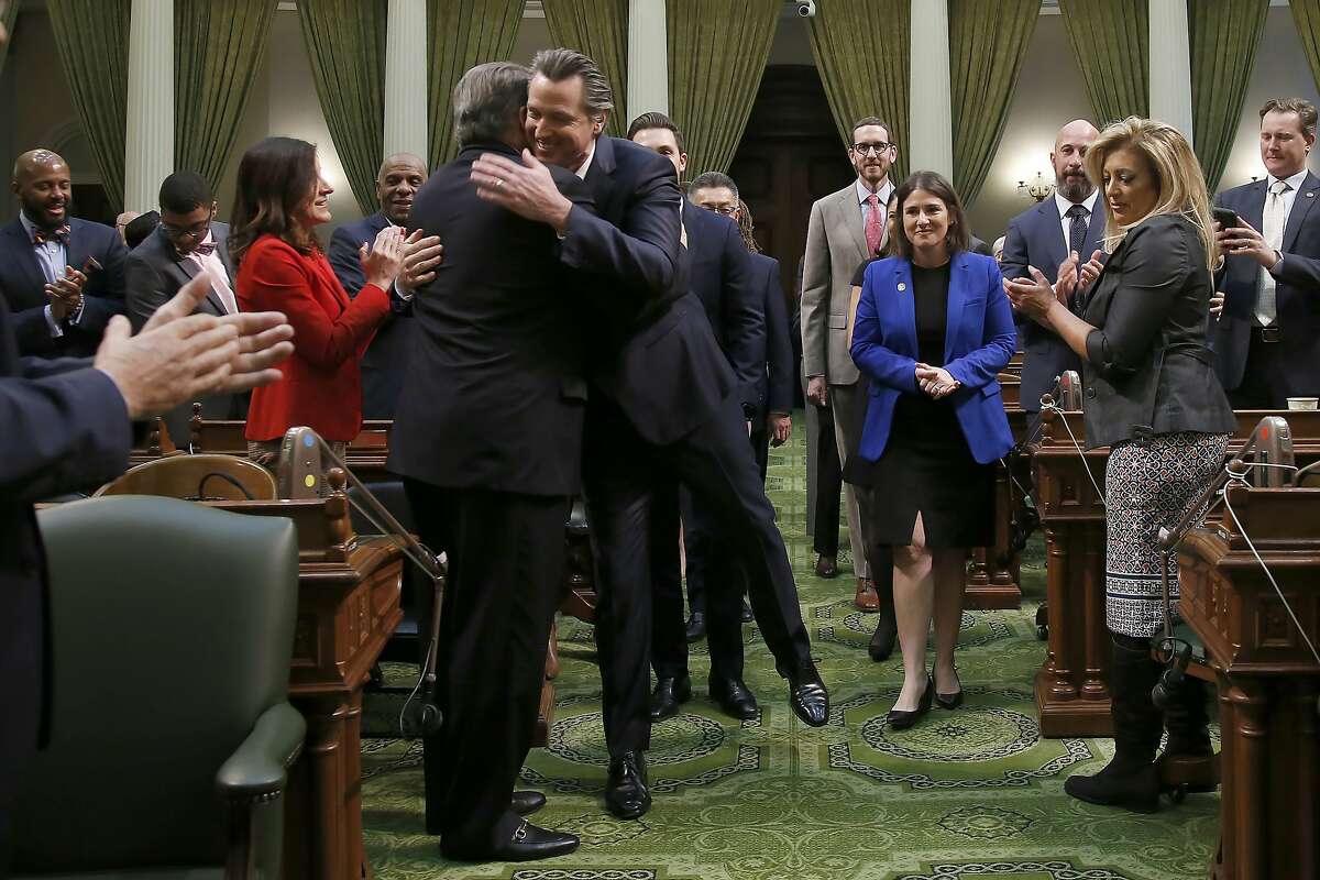 California Gov. Gavin Newsom, center, is greeted by Democratic state Sen. Robert Hertzberg, as he enters the Assembly Chambers to give his State of the State address to a joint session of the legislature at the Capitol in Sacramento, Calif., Wednesday, Feb. 19, 2020. (AP Photo/Rich Pedroncelli, Pool)