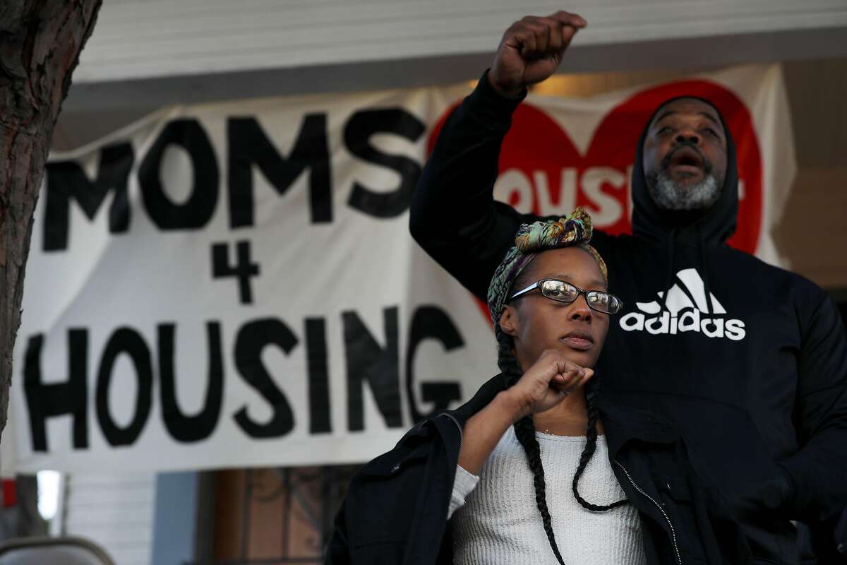Dominique Walker, co-founder, Moms 4 Housing, and Tur-Ha, with Community Ready Core, stand on porch steps of the Magnolia Street house Walker and other homeless mothers had been occupying as they face supporters following an eviction in Oakland, Calif., on Tuesday, January 14, 2020. Moms 4 housing members Misty Cross and Tolani King were arrested early Tuesday morning. A third person, Jesse Turner, was also arrested. A judge on Friday ruled that Moms 4 Housing didn't have a legal right to the property and that they would be evicted by the Sheriff's Office within days.