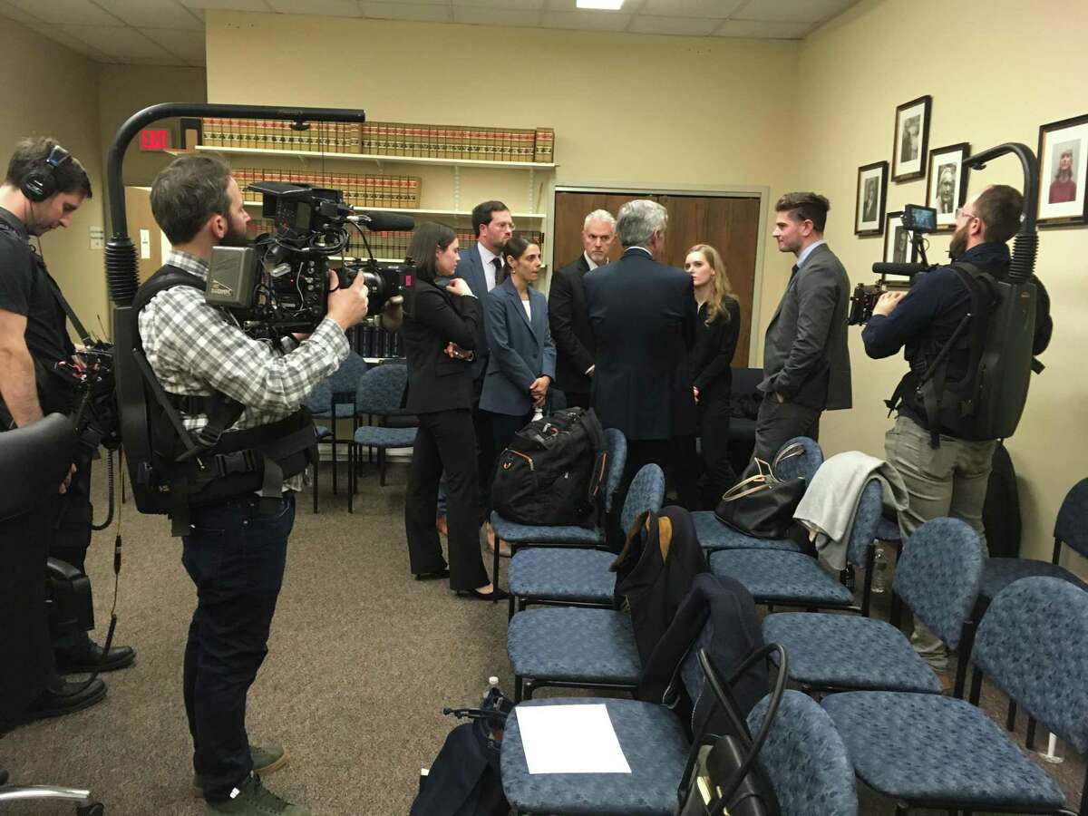 Attendees gather at the end of an FOI hearing in Hartford, Conn. on Feb. 19, 2020. The hearing will help determine whether the Madison Police Department is exempt from releasing records in the cold case murder of Barbara Hamburg. Second from right is Hamburg's son, Madison Hamburg, who is making a documentary film about his mother. Cameramen working with the company producing the film are present.