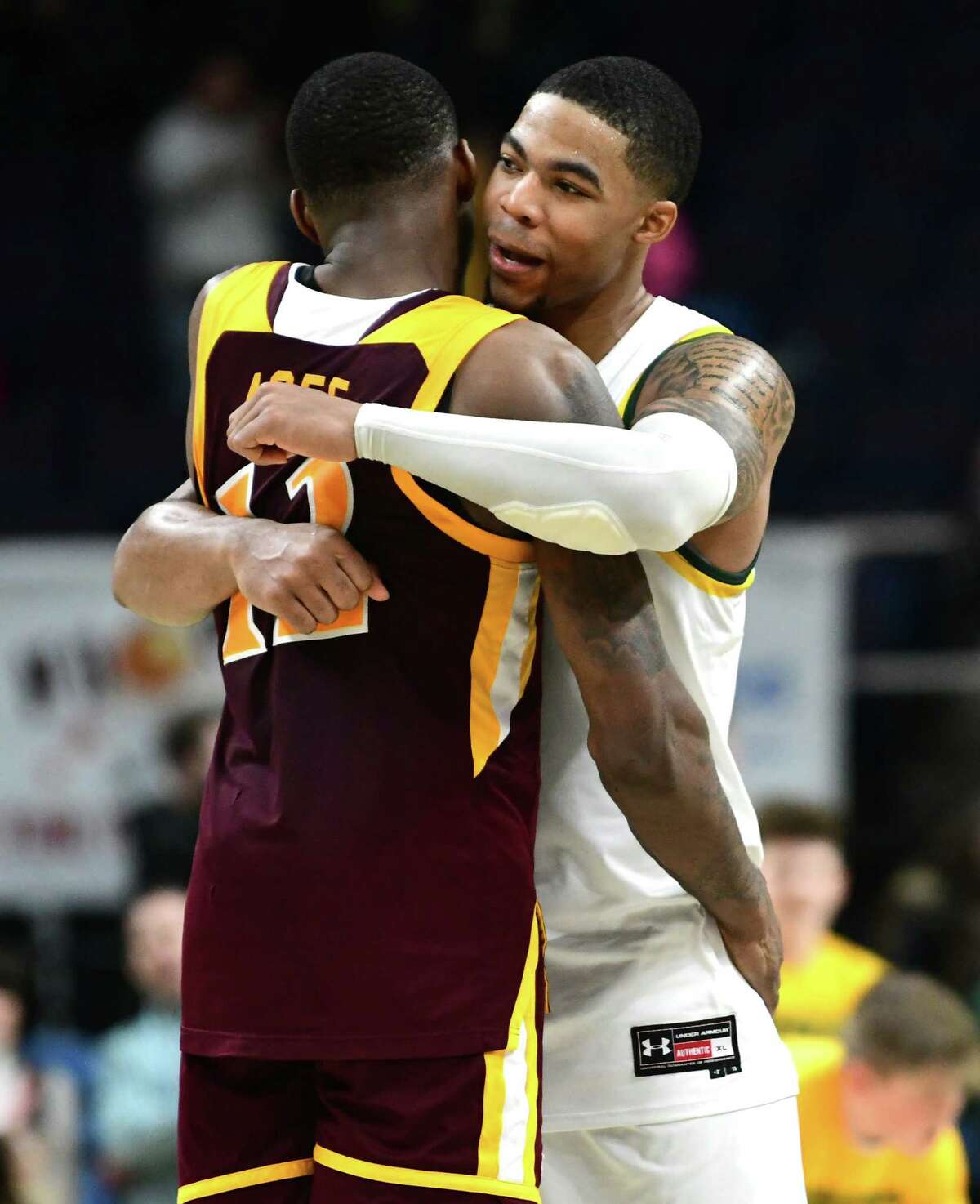 Siena's Elijah Burns, right, hugs Iona's Tajuan Agee after Siena's win at the Times Union Center on Wednesday, Feb. 19, 2020 in Albany, N.Y. (Lori Van Buren/Times Union)