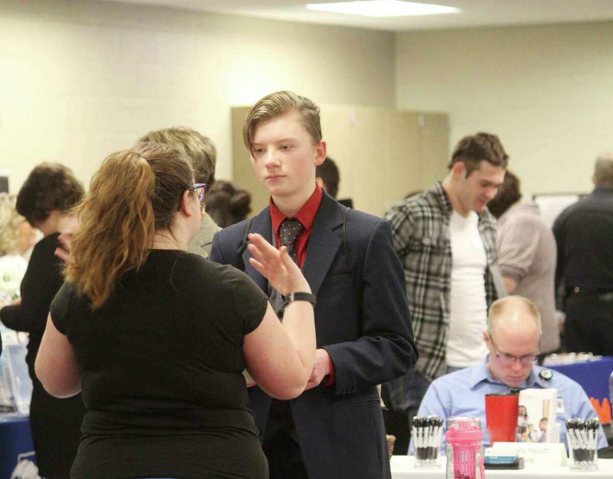 A student talks with a local business representative during the Career Expo. There were about 60 employers at this year's event. (Pioneer photo/Catherine Sweeney)