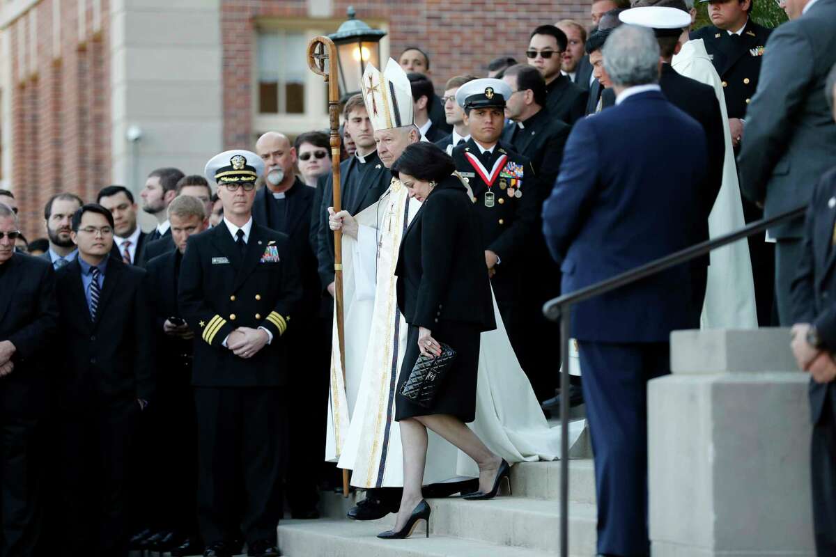 FILE - In this March 21, 2018, file photo, Gayle Benson, widow of NFL New Orleans Saints and NBA New Orleans Pelicans owner Tom Benson, walks down the steps to receive his casket with New Orleans Archbishop Gregory Aymond for visitation at Notre Dame Seminary in New Orleans. Attorneys for several men suing the Roman Catholic church say documents they obtained through discovery show that the New Orleans Saints team aided the Archdiocese of New Orleans in its “pattern and practice of concealing its crimes.” (AP Photo/Gerald Herbert, File)
