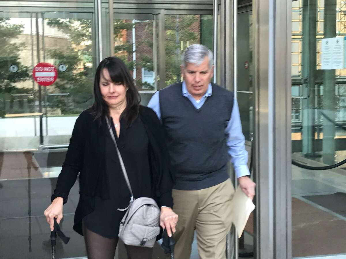 Carrie Maturo and her husband Frank, of Darien, leave the Stamford courthouse after the man who crashed into her car while driving drunk, partially paralyzing her, was sentenced to 10 years in jail.