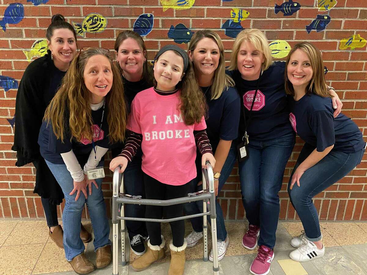 Six members of the Babysitting for Brooke committee surrounded Brooke Blake. From left are Kim Van Allsburg, Sarah Farina, Leah Hayner, Brooke Blake, Emily Sherwill, Patricia Dowd and Autumn Hoey.