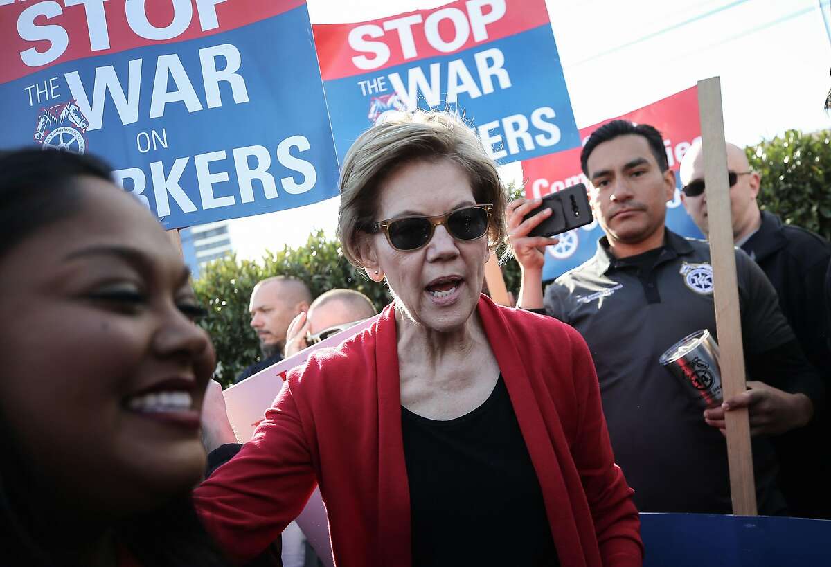 LAS VEGAS, NEVADA - FEBRUARY 19: Democratic presidential candidate Sen. Elizabeth Warren (D-MA) (C) walks with members of Culinary Workers Union Local 226 on a picket line outside of Palms Casino Resort on February 19, 2020 in Las Vegas, Nevada. The upcoming Nevada Democratic presidential caucus will be held February 22 and a Democratic presidential debate will be held later today in Las Vegas. (Photo by Mario Tama/Getty Images)
