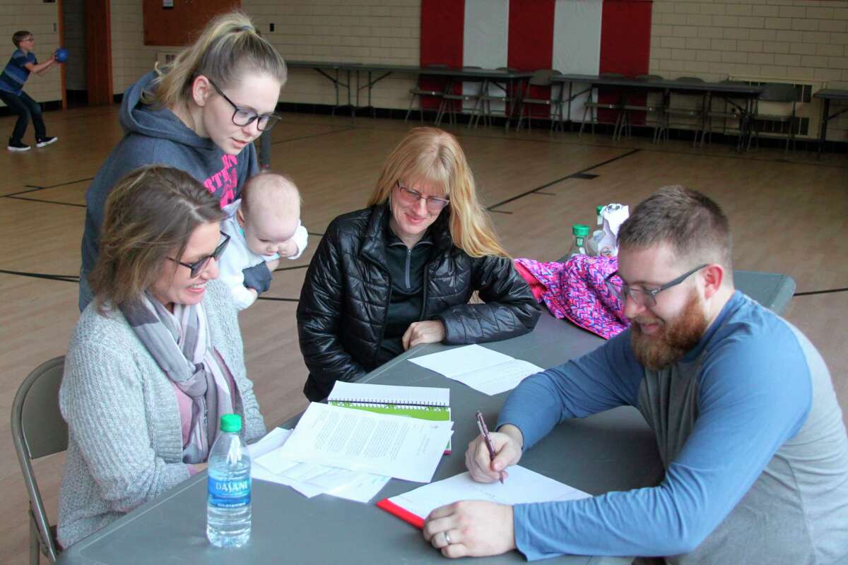 Members of the Trinity Lutheran Church Roast Pork and Sauerkraut Supper make plans for the upcoming event that will take place from 5-7 p.m. on March 14. Pictured (left to right) are Melissa Gentz,  Michaela Guerra, Sky Mage and Greg Staffeld making plans for the event. (Ken Grabowski/News Advocate)