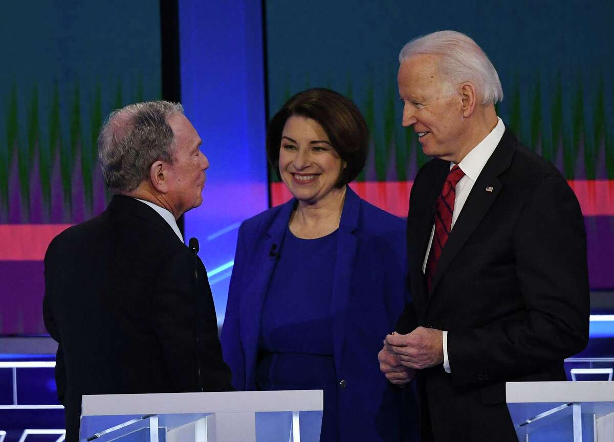 Democratic presidential hopefuls Former New York Mayor Mike Bloomberg (L), Indiana Senator Amy Klobuchar and Former Vice President Joe Biden (R) talk during abreak during the Democratic Presidential Debate hosted by NBC News and MSNBC with The Nevada Independent at the Paris Las Vegas Hotel in Las Vegas, Nevada, on February 19, 2020. (Photo by Mark RALSTON / AFP) (Photo by MARK RALSTON/AFP via Getty Images)