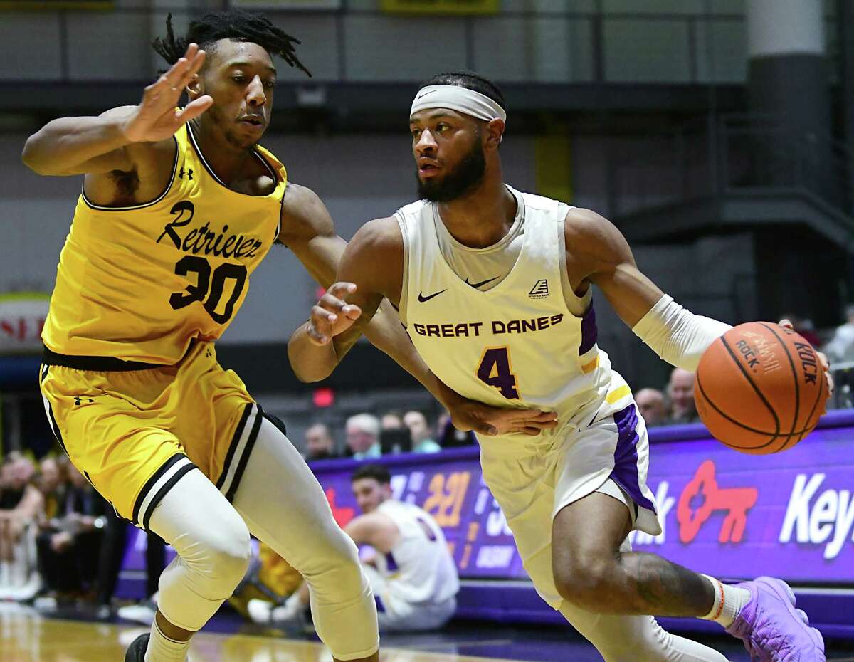 University at Albany's Ahmad Clark drives to the basket against Maryland-Baltimore County's Daniel Akin during a game at SEFCU Arena on Thursday, Feb. 20, 2020 in Albany, N.Y. (Lori Van Buren/Times Union)