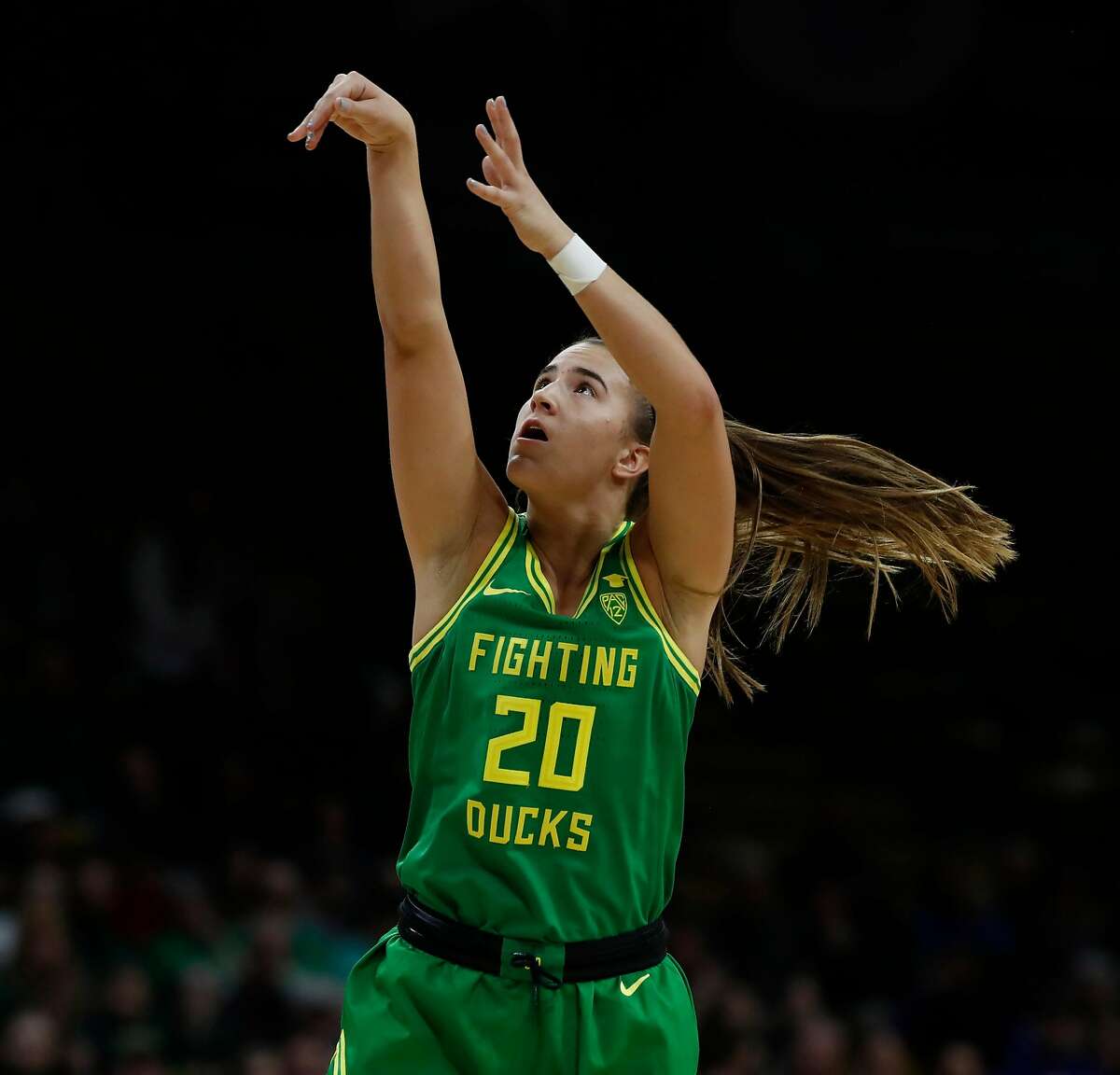 Sabrina Ionescu in action, showcasing her impressive shooting form and technique, which contributed to her remarkable college stats