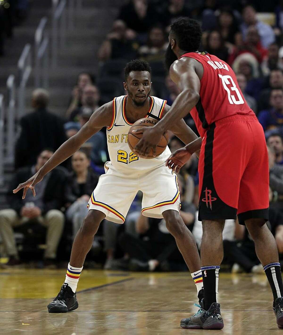 Andrew Wiggins (22) defends against James Harden (13) In the first half as the Golden State Warriors played the Houston Rockets at Chase Center in San Francisco, Calif., on Thursday, February 20, 2020.