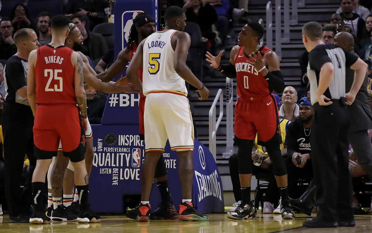 Houston Rockets' Russell Westbrook (0) gestures while speaking to Golden State Warriors' Kevon Looney (5) in the fourth quarter of an NBA basketball game Thursday, Feb. 20, 2020, in San Francisco. Westbrook was ejected after receiving a second technical foul in the fourth quarter.