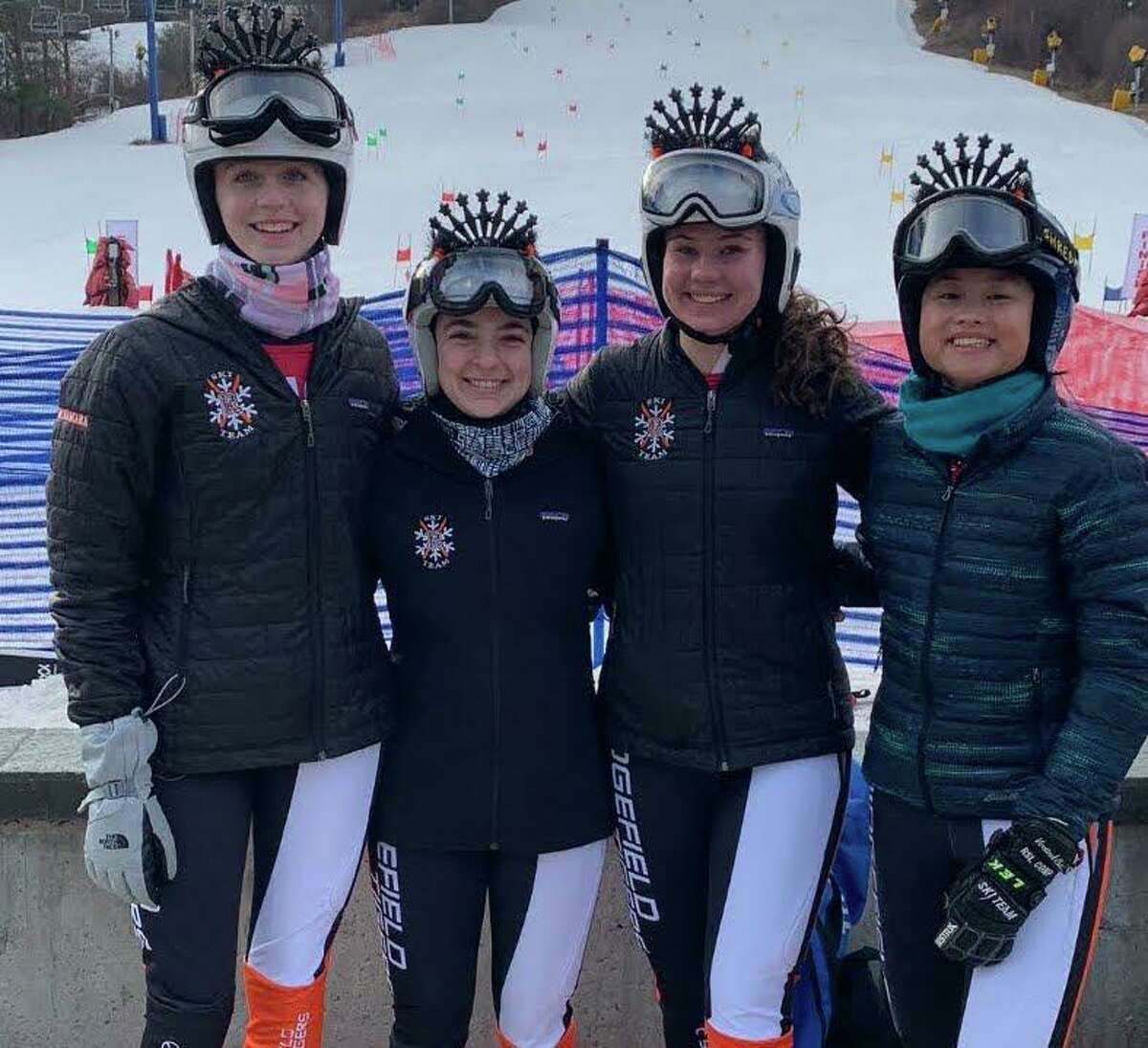 The Ridgefield girls ski team recognized its four seniors — Kiley McNamara, Chelsea Schwartz, Grace Bucci, and Lauren Tsai (left to right) — at a recent meet. The RHS boys team has no seniors this season.