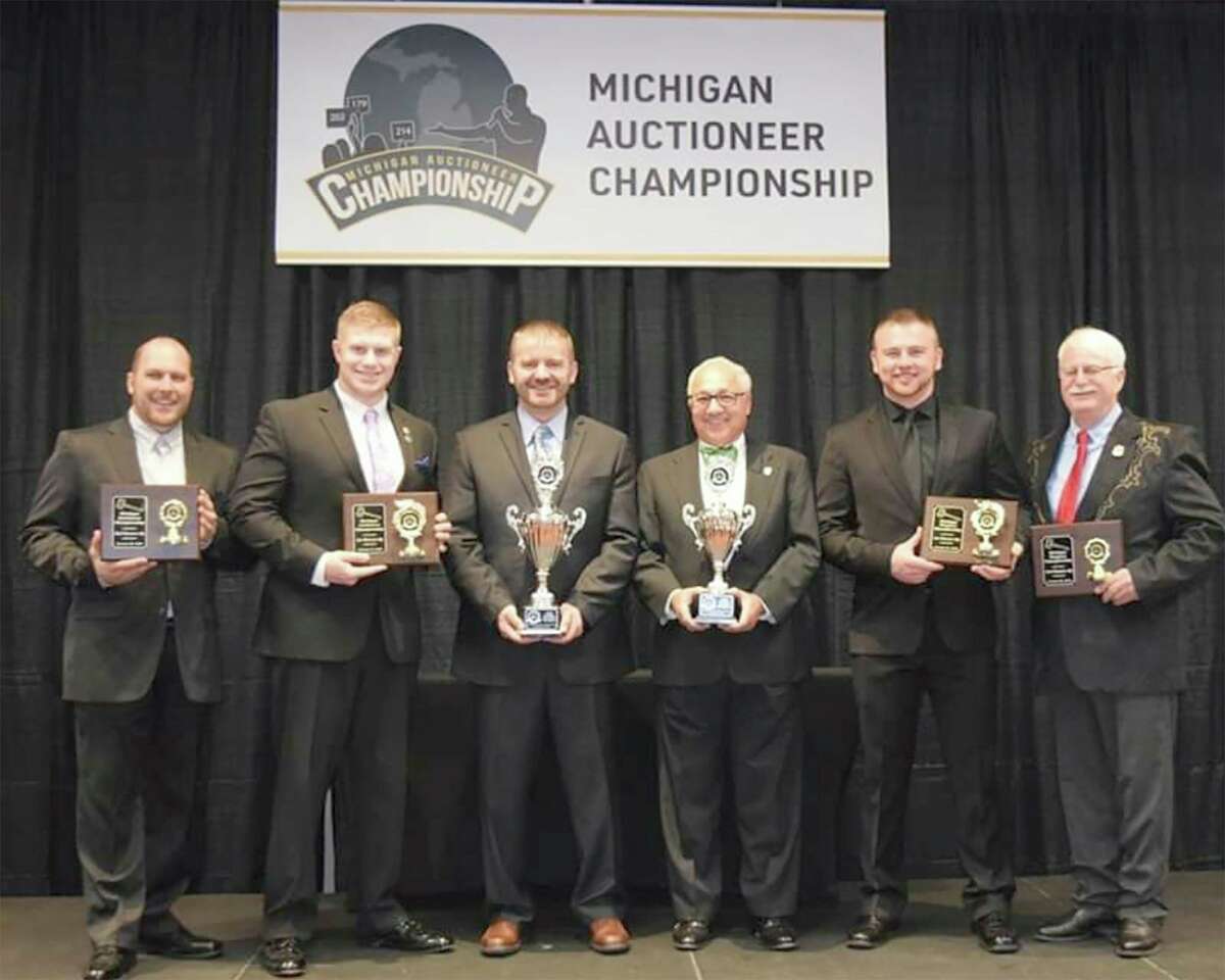 Jason Clark, third from the left, stands in the winner's circle at the Michigan Auctioneers Association's annual conference Jan. 30 in Mount Pleasant. He competed against 16 contestants to win the 2020 Michigan Auctioneer Championship. (Courtesy photo/Jason Clark)