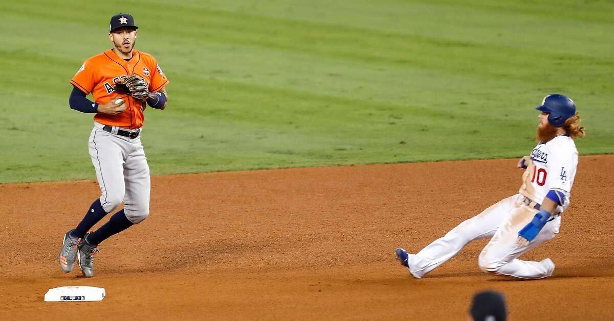 Houston Astros shortstop Carlos Correa (1) forces out Los Angeles Dodgers third baseman Justin Turner (10) on a fielders choice during the fifth inning of Game 7 of the World Series at Dodger Stadium on Wednesday, Nov. 1, 2017, in Los Angeles. ( Brett Coomer / Houston Chronicle )