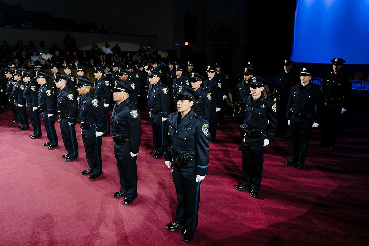 Graduating cadets stand at attention during the Oakland Police Department’s 183rd Basic Recruit Academy Graduation at the Scottish Rite Center in Oakland in February. A proposed California law would require candidates to have at least a bachelor’s degree, or wait until they are 25 years old, to enter a police academy.