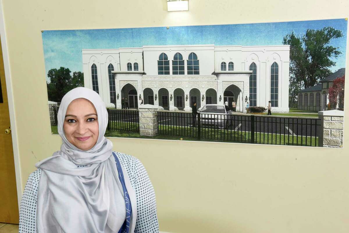 Malika Haider stands by an architectural drawing of the Al Fatemah Center which hangs in the center on Thursday, Feb. 6, 2020 in Albany, N.Y. (Lori Van Buren/Times Union)