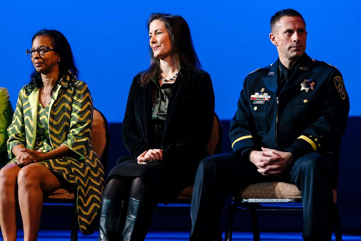 Acting Oakland Police Chief Darren Allison, right, Oakland Mayor Libby Schaaf, and Oakland Police Commission chair Regina Jackson sit on stage during the Oakland Police Department's 183rd Basic Recruit Academy Graduation held at the Scottish Rite Center in Oakland, California, on Friday, Feb. 21, 2020. The Oakland Police Commission voted unanimously in a closed session on Thursday to fire Police Chief Anne Kirkpatrick.