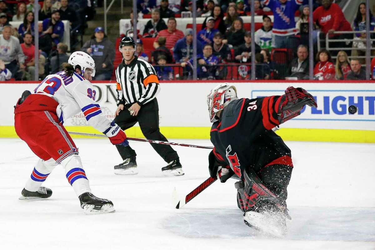 New York Rangers center Mika Zibanejad (93), of Sweden, shoots and scores against Carolina Hurricanes goaltender Petr Mrazek (34), of the Czech Republic, during the first period of an NHL hockey game in Raleigh, N.C., Friday, Feb. 21, 2020. (AP Photo/Gerry Broome)